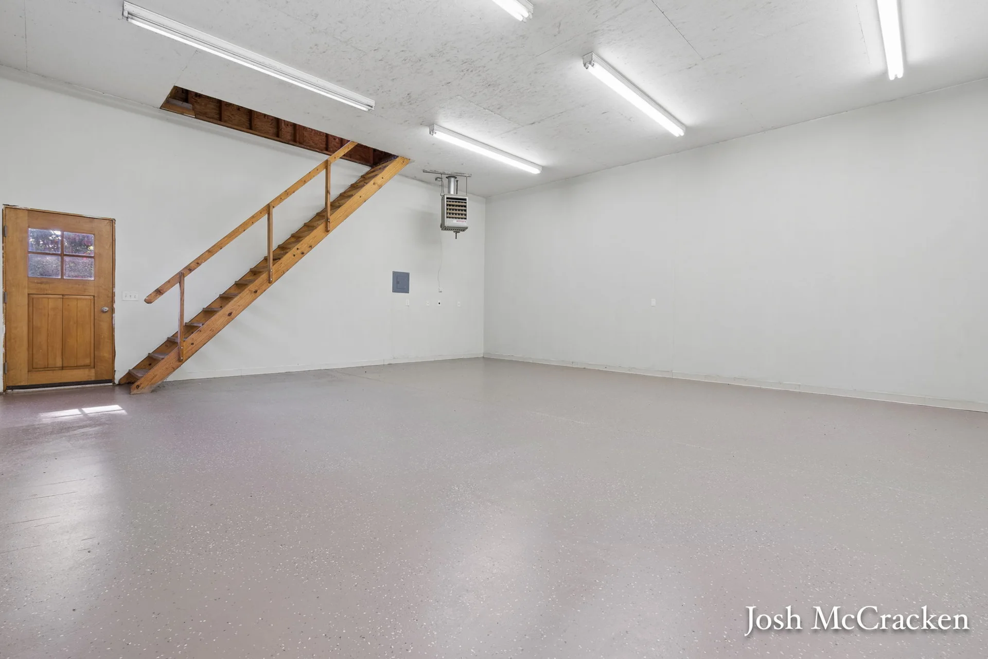 Finished barn interior with stairs to the upper area