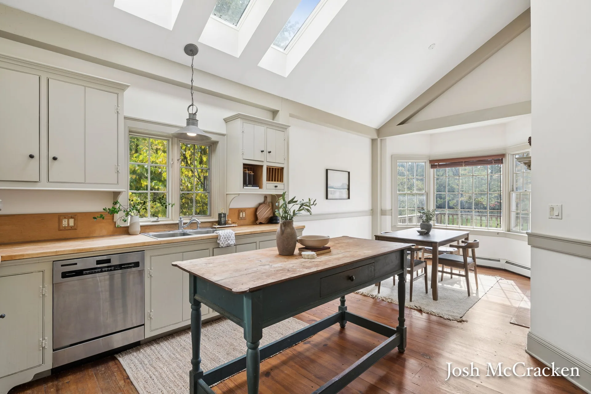 Kitchen with skylights, wood countertops and bay-window dining area