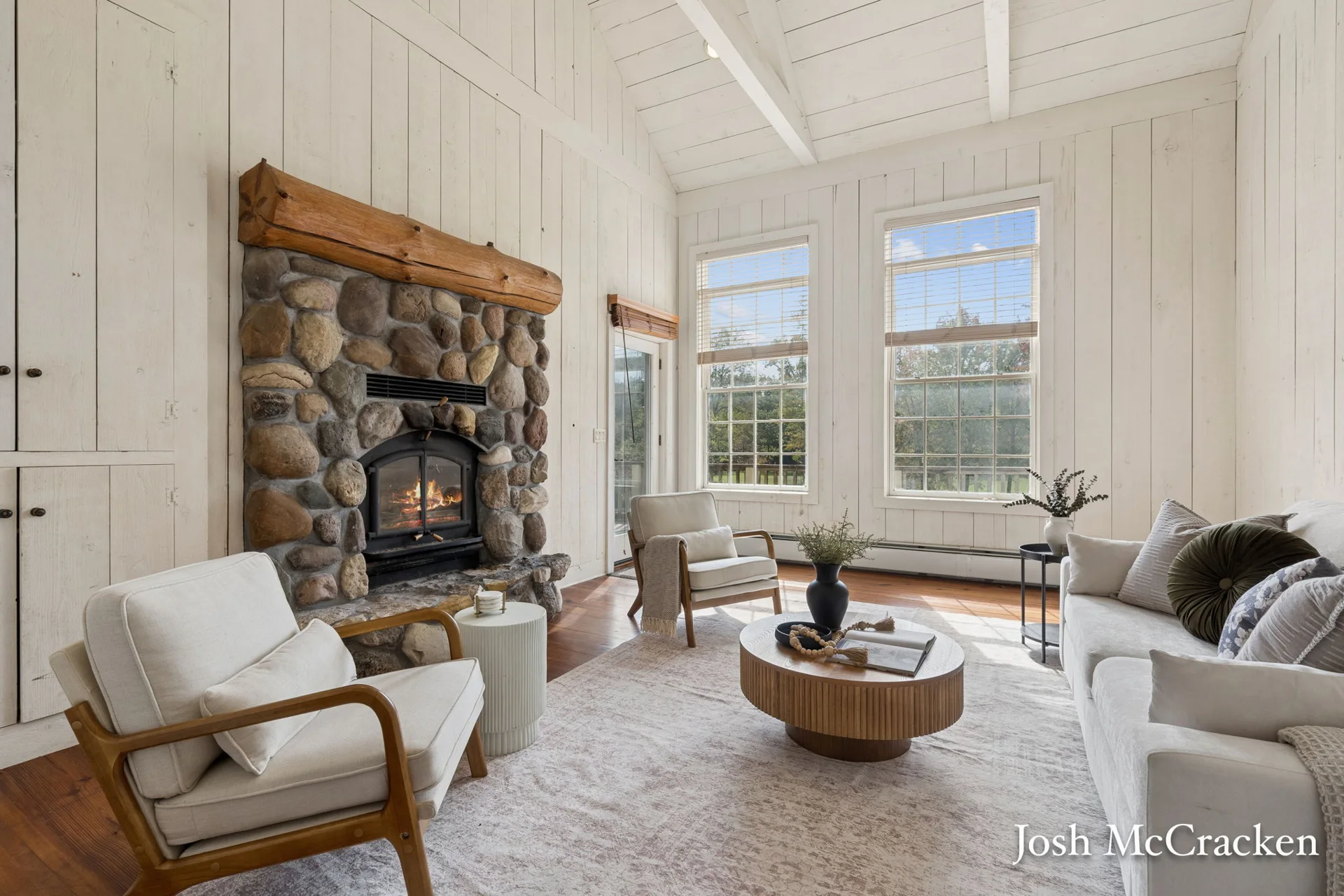 Fieldstone fireplace, timber mantel and heart-pine flooring in the living room